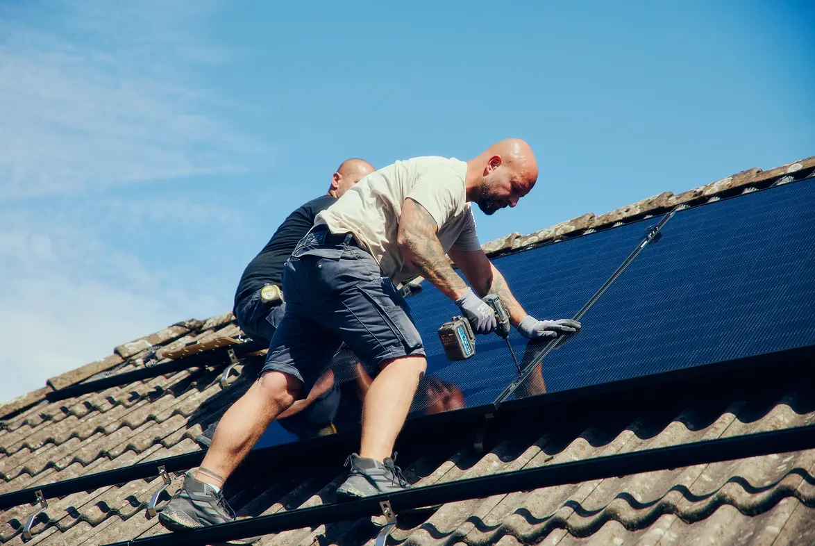 Monteur für PV-Anlagen auf einem Dach